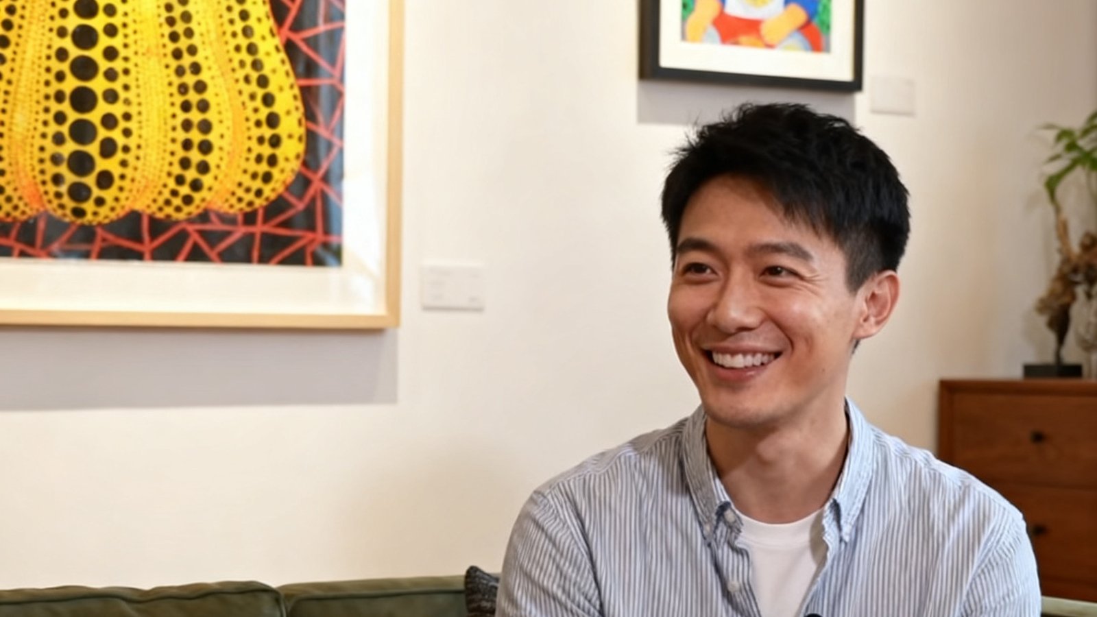 一位三十岁出头的年轻藏家在其上海公寓中接受采访，背景墙上悬挂着刘野和草间弥生的作品，他正微笑着讲述自己从科技行业跨界进入艺术收藏领域的独特经历。